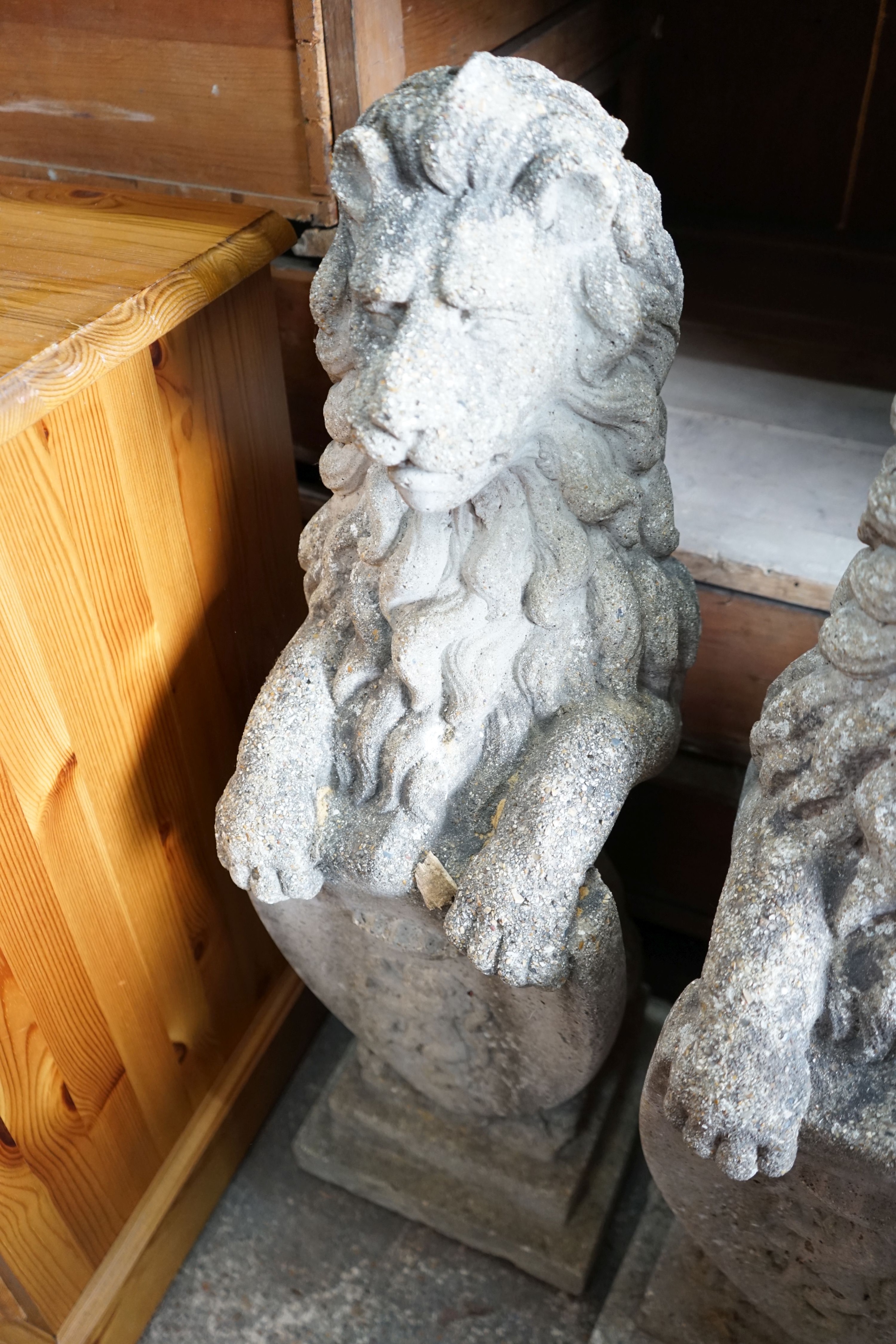 A pair of reconstituted stone heraldic lions, height 80cm